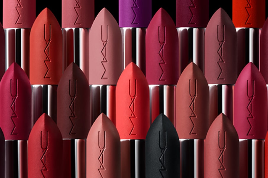 Multiple MAC lipsticks angled across a blue background